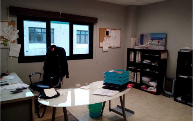 Foto de interior de la oficina con mesa y estanterías